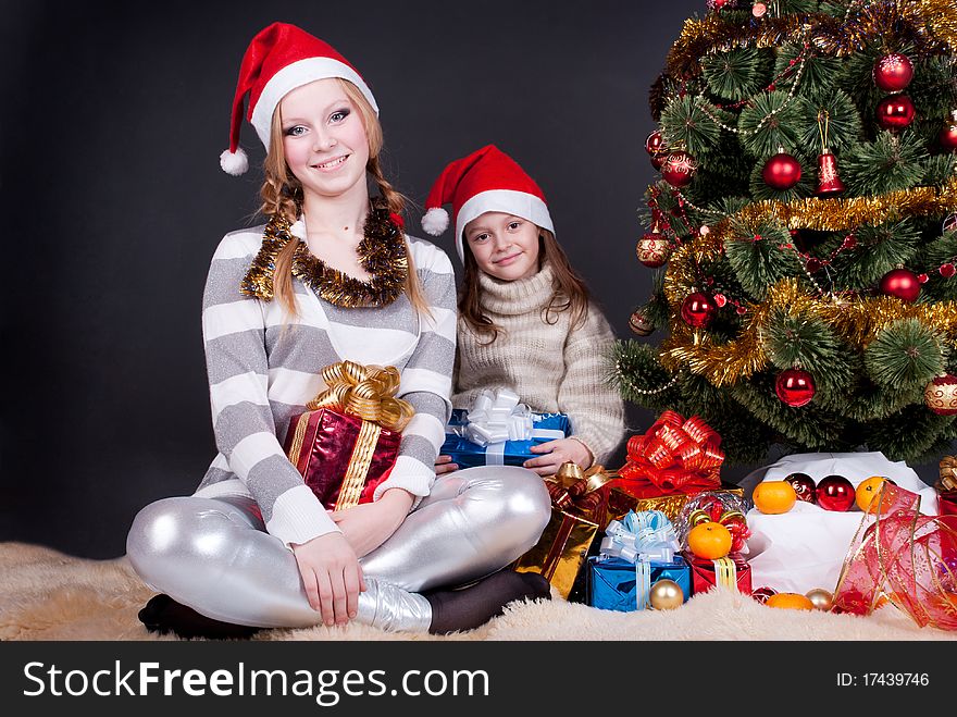 Two little girls are waiting for Christmas