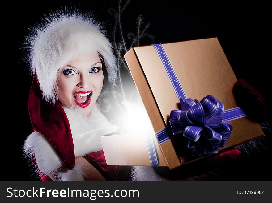 Young sexy woman in santa clothing. Opening a gift box. Young sexy woman in santa clothing. Opening a gift box.