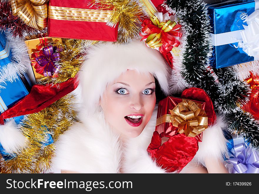 Christmas girl in santa hat with stack gift box. Christmas girl in santa hat with stack gift box