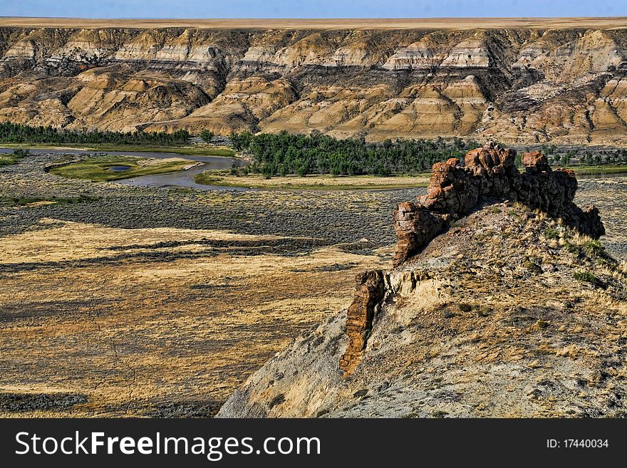 A close up of a badlands formation in the Milk river valley with the Milk river in the background. A close up of a badlands formation in the Milk river valley with the Milk river in the background.