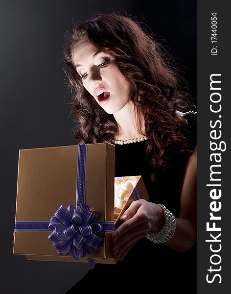 Beautiful young brunette woman with a present