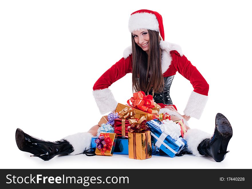 Beautiful woman dressed as Santa Claus sitting with a bunch of gifts isolated with white background