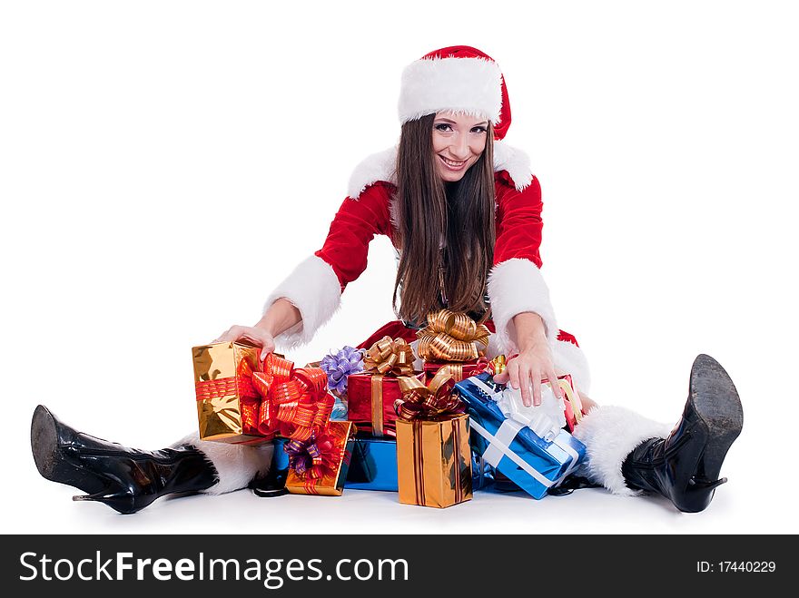 Beautiful girl dressed as Santa Claus sitting with a bunch of gifts isolated with white background. Beautiful girl dressed as Santa Claus sitting with a bunch of gifts isolated with white background