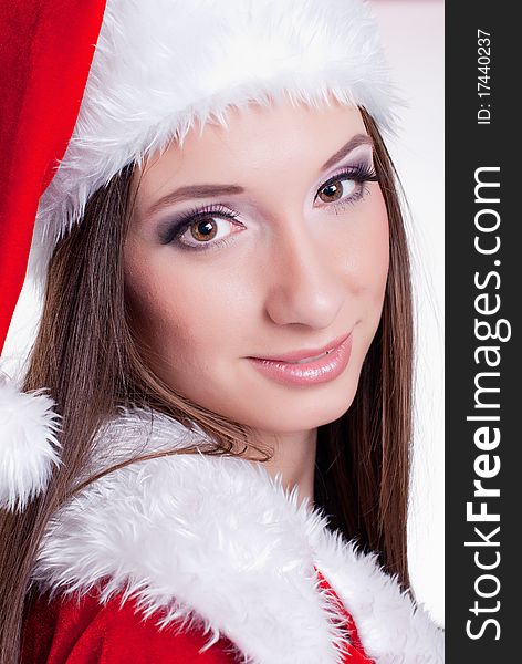 Young smiling beautiful girl in santa claus hat. Young smiling beautiful girl in santa claus hat