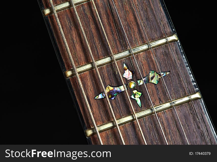 A nice inlay on an electric guitar against a black background. A nice inlay on an electric guitar against a black background