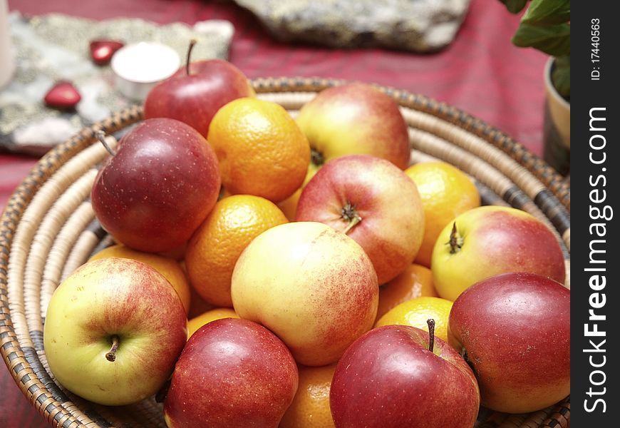 Red apples and mandarin oranges in a basket