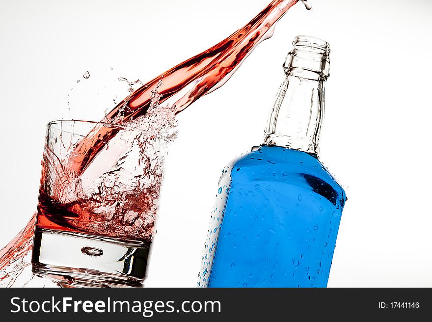 Splashing red drink isolated on the white