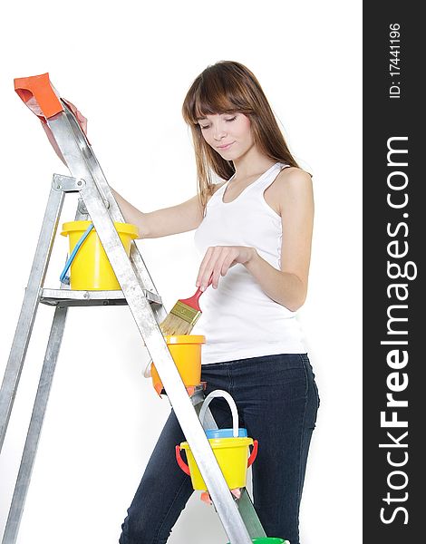 Studio portrait of young woman with paintbrush