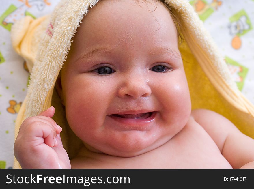 A smiling girl in a yellow towel after bath. A smiling girl in a yellow towel after bath