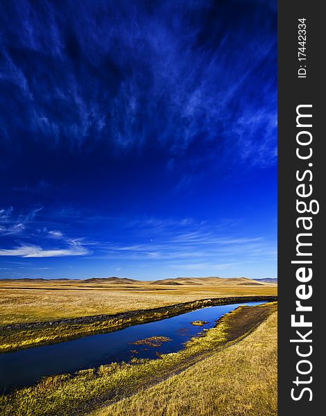 Stream between pastures and sky. Stream between pastures and sky.