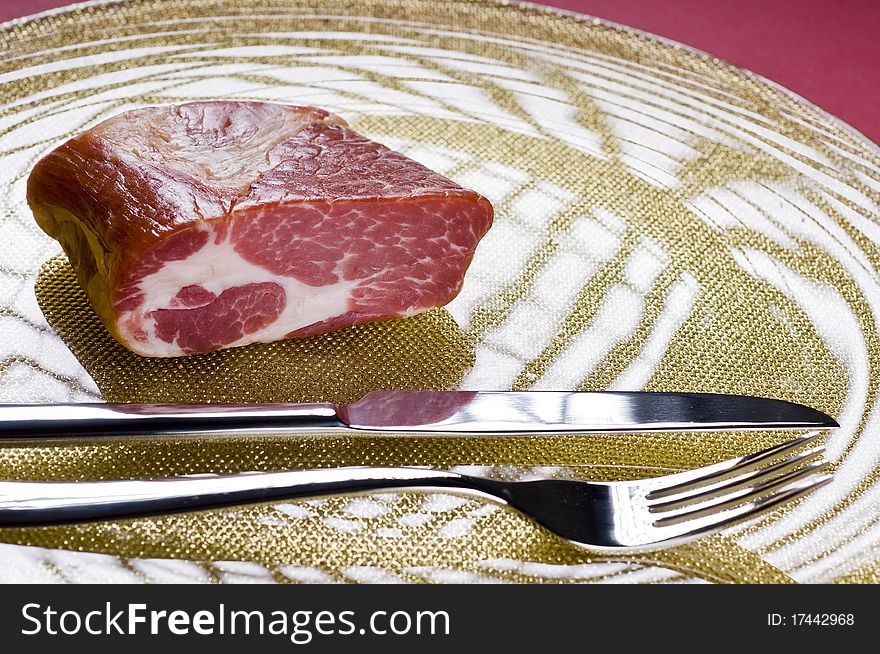 Raw meat on a plate over color background
