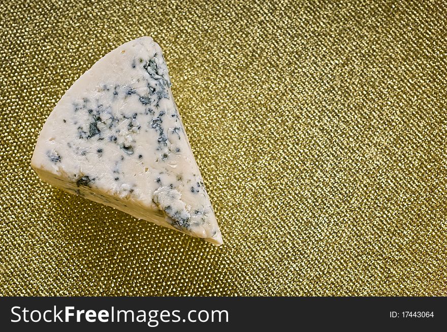 Blue cheese on a plate over colored background