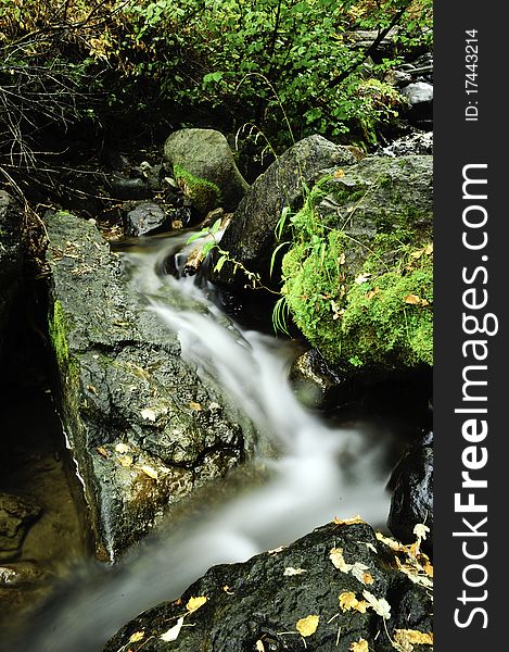 A slow moving creek cascading down granite rocks