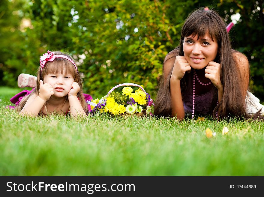 Mother and little girl on meadow