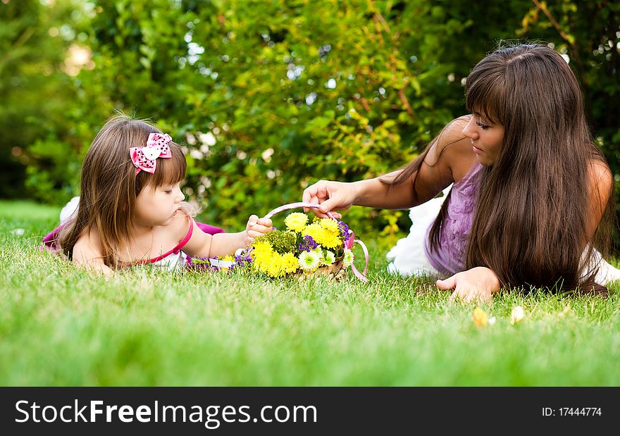 Mother and little girl on meadow