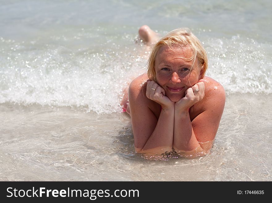 A beautiful young blond woman in a crystal clear blue sea. A beautiful young blond woman in a crystal clear blue sea