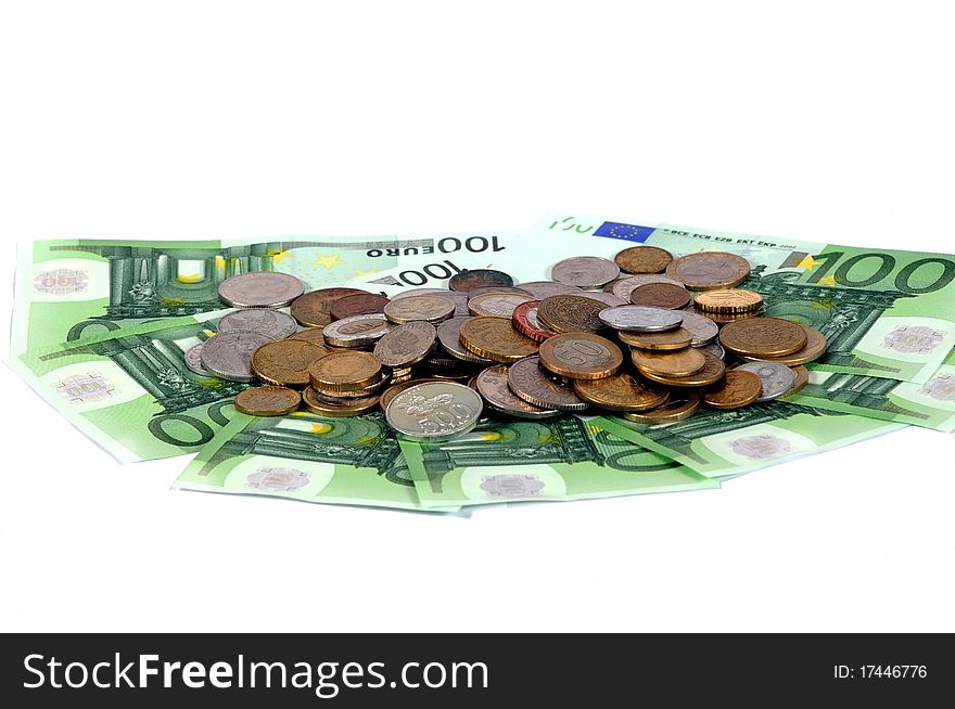 Banknotes and coins on the table on a white background. Banknotes and coins on the table on a white background