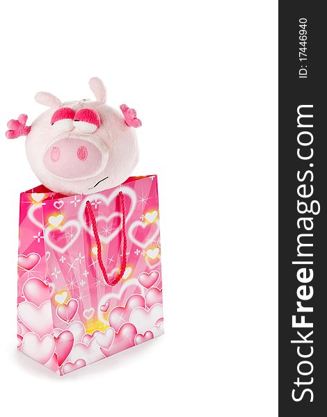 Toy pink piglet as christmas gift isolated on white