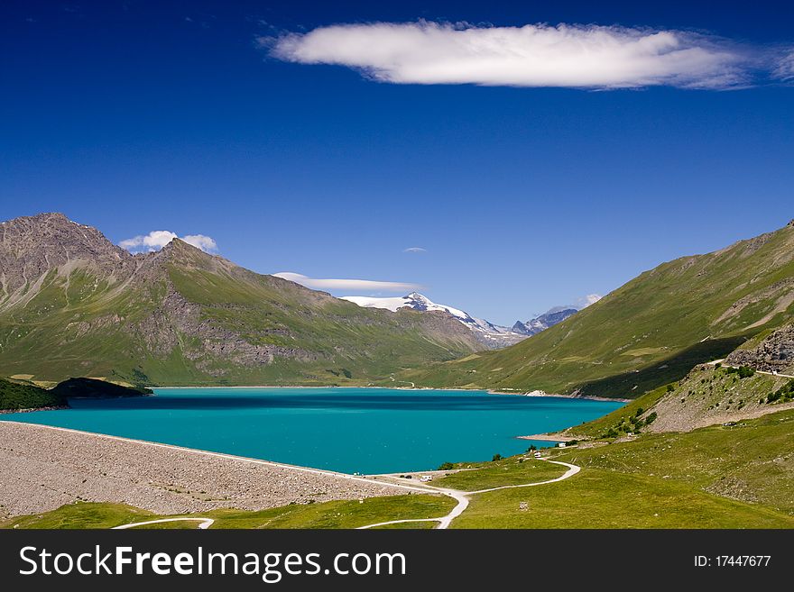 Turquoise alpine lake; France, The Alps