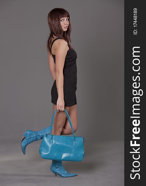 Portrait of fashion woman with blue bag