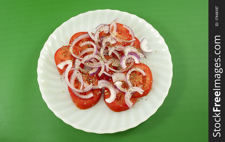 Tomato and onion salad isolated on white background