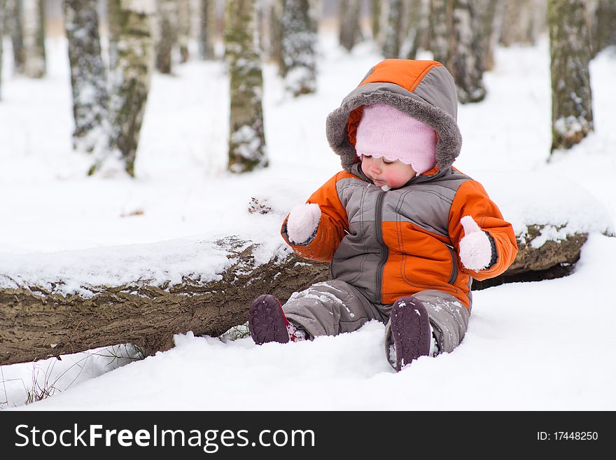 Cute Baby Sit On Snow And Play With Mittens