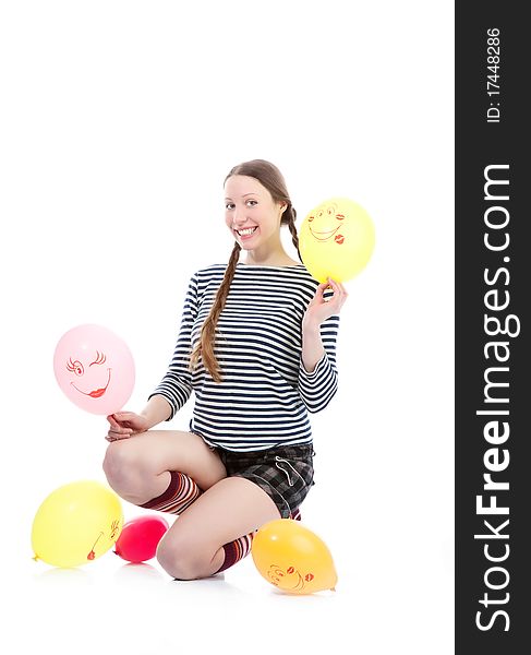 A pretty girl dressed in casual clothes playing with baloons. A pretty girl dressed in casual clothes playing with baloons