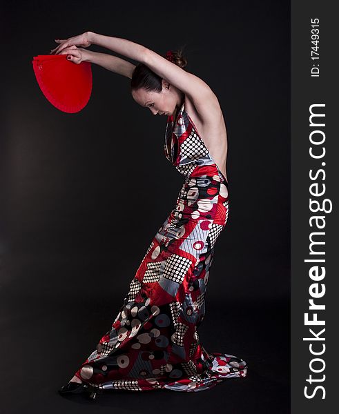 Image of a flamenco woman dancer with red fan.