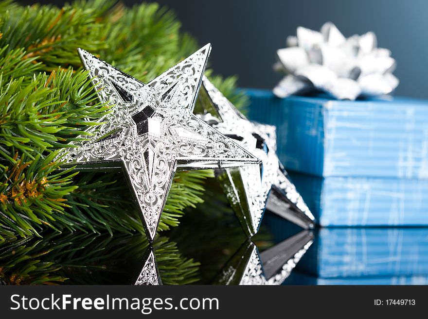 Branch of Christmas tree with gift box and star