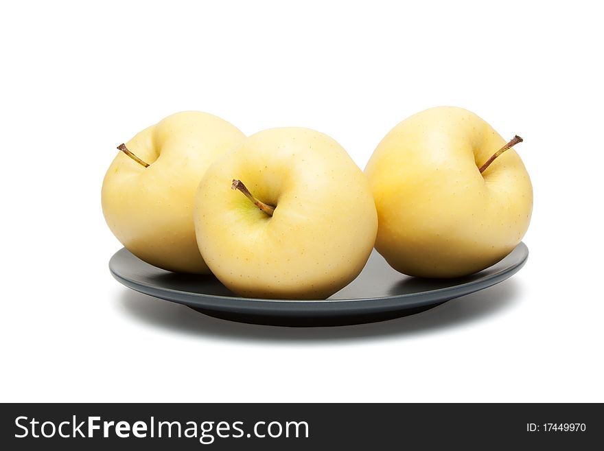 Yellow apples on plate isolated on a white background