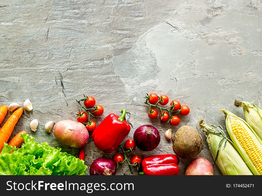 Set of autumn vegetables - potato, cucumber, carrot, greenery - on grey background top-down. Set of autumn vegetables - potato, cucumber, carrot, greenery - on grey background top-down.