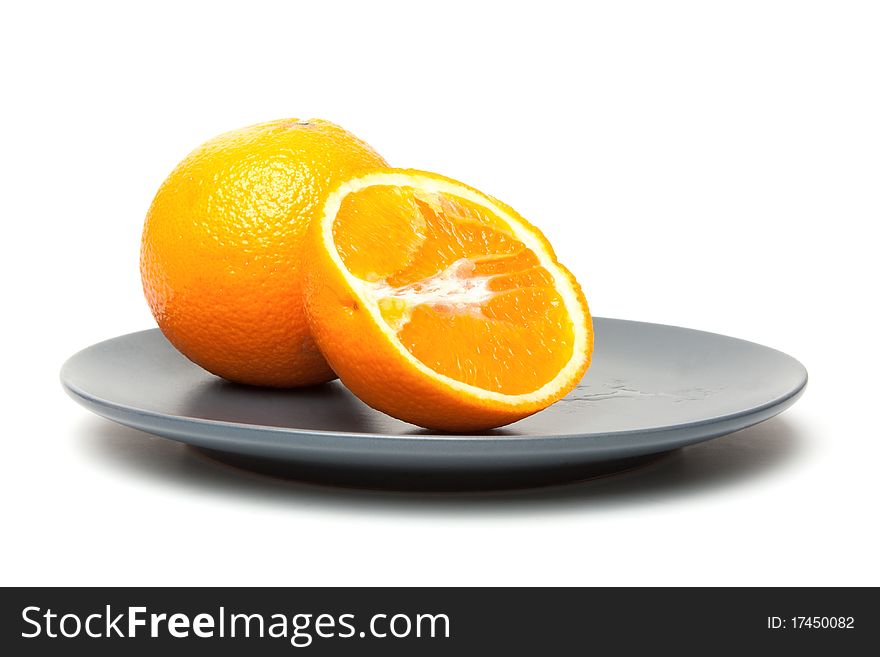 Orange on plate isolate on a white background. Orange on plate isolate on a white background