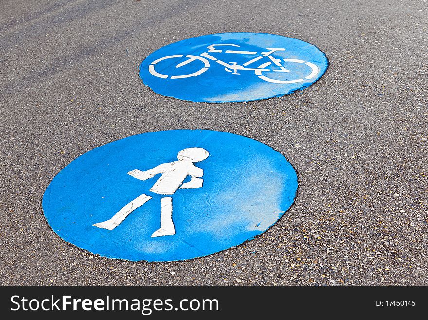 Symbol for pathway and icon for pedestrians on asphalt