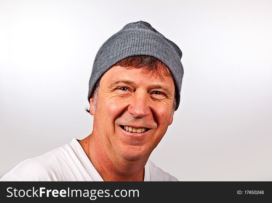 Smiling man with cap isolated on a white background. Smiling man with cap isolated on a white background