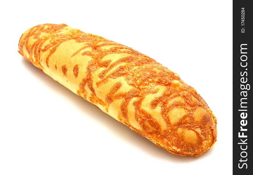 The ruddy long loaf of bread is strewed by cheese isolated on a white background