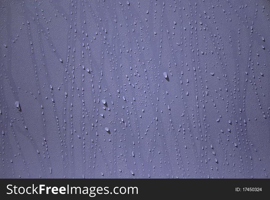 Water drop on the purple wall. Water drop on the purple wall