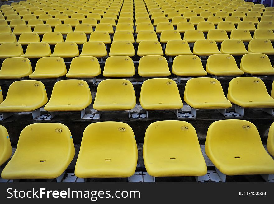 Yellow plastic seat in the stadium
