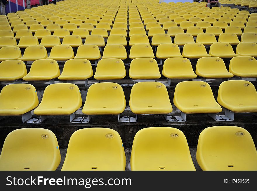 Yellow plastic chair in the stadium