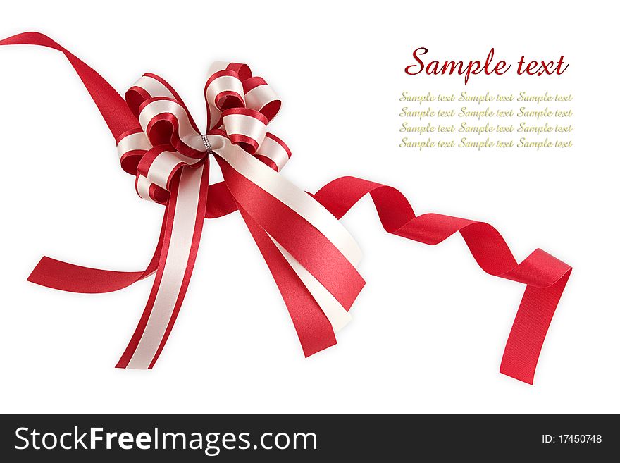 Shiny red ribbon bow on white background with copy space