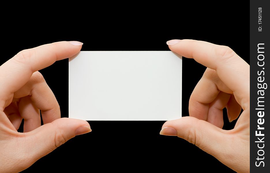 Paper card in woman hand isolated on black background