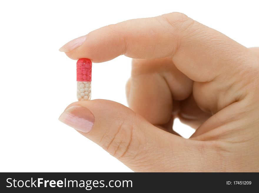 Hand with a pill on white background