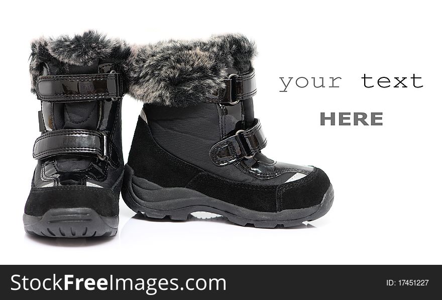 Black child's winter boots isolated on white background (with space for text)