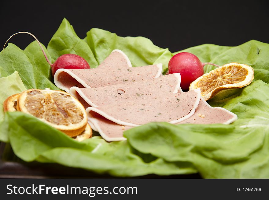 Liver pastry with lemon onto lettuce leaves