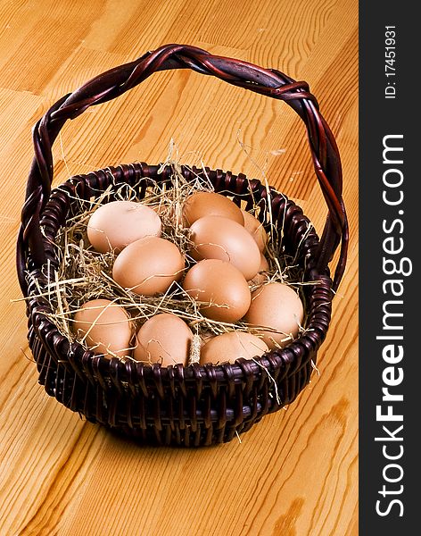 Fresh farm eggs in the basket with hay. Fresh farm eggs in the basket with hay