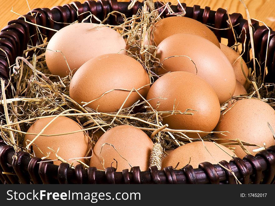 Fresh farm eggs in the basket with hay. Fresh farm eggs in the basket with hay