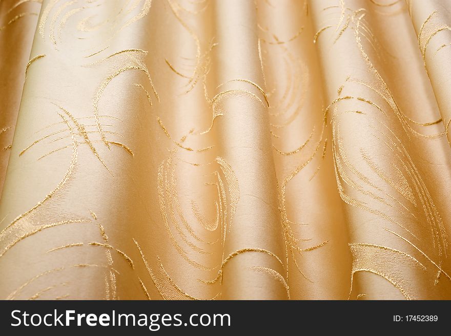The background of textured of curtain fabric with a pattern closeup. The background of textured of curtain fabric with a pattern closeup