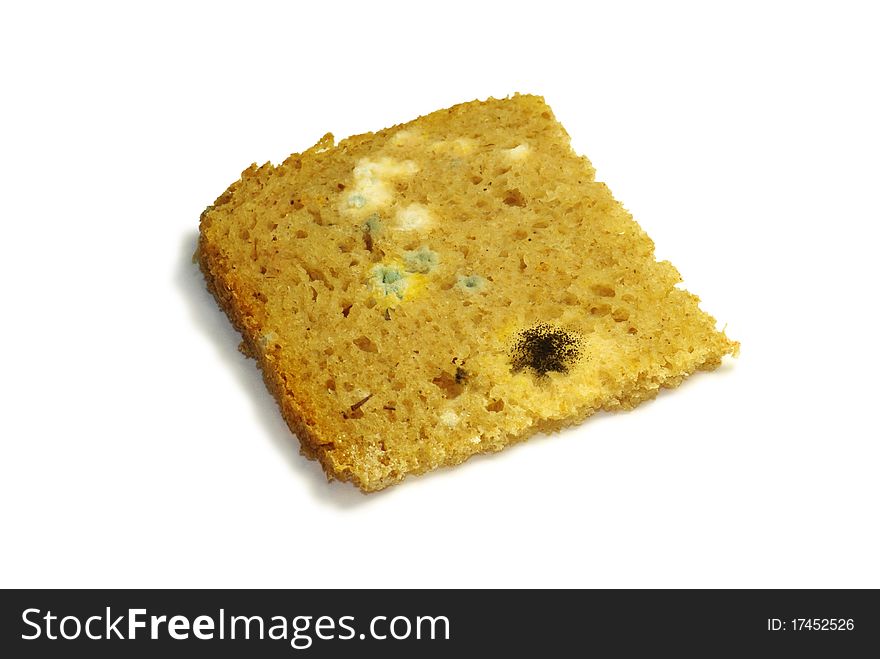 Loaf of mouldy bread against a white background