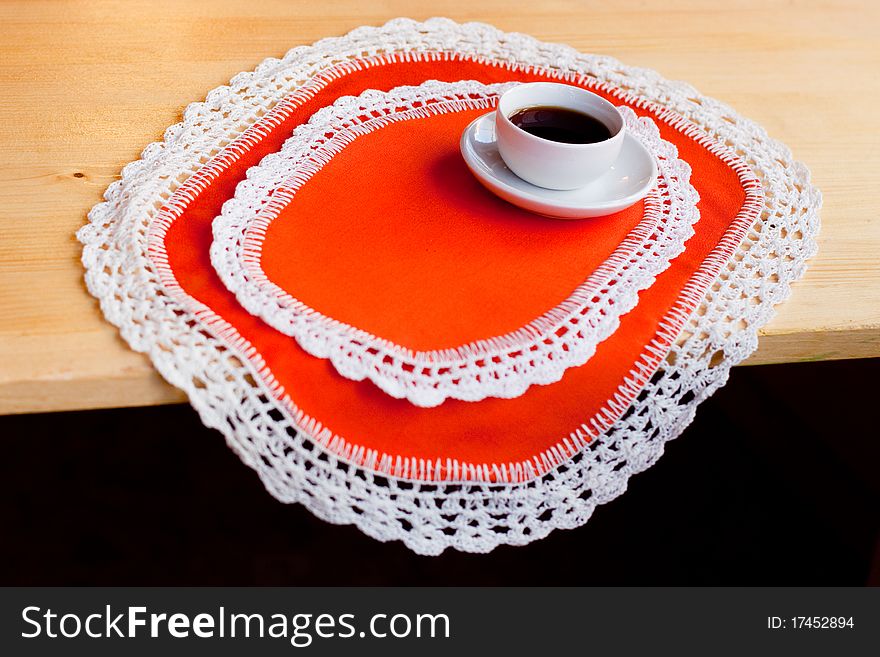 A coffee cup on two orange napkins