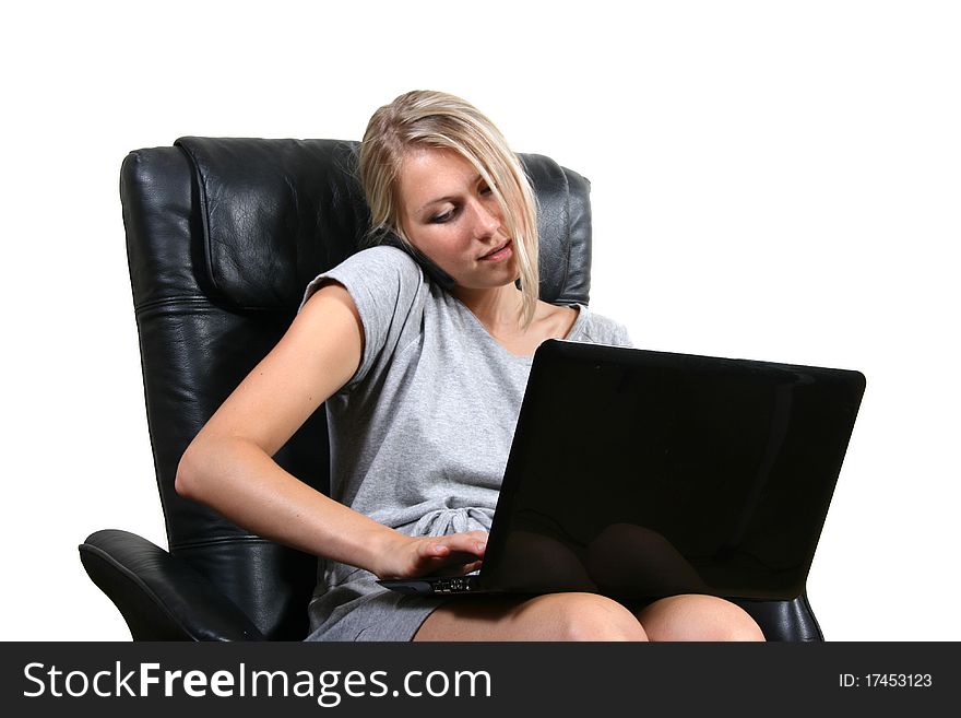 Woman in chair with laptop and phone isolated on white