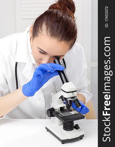 Medical - Female nurse looking in microscope